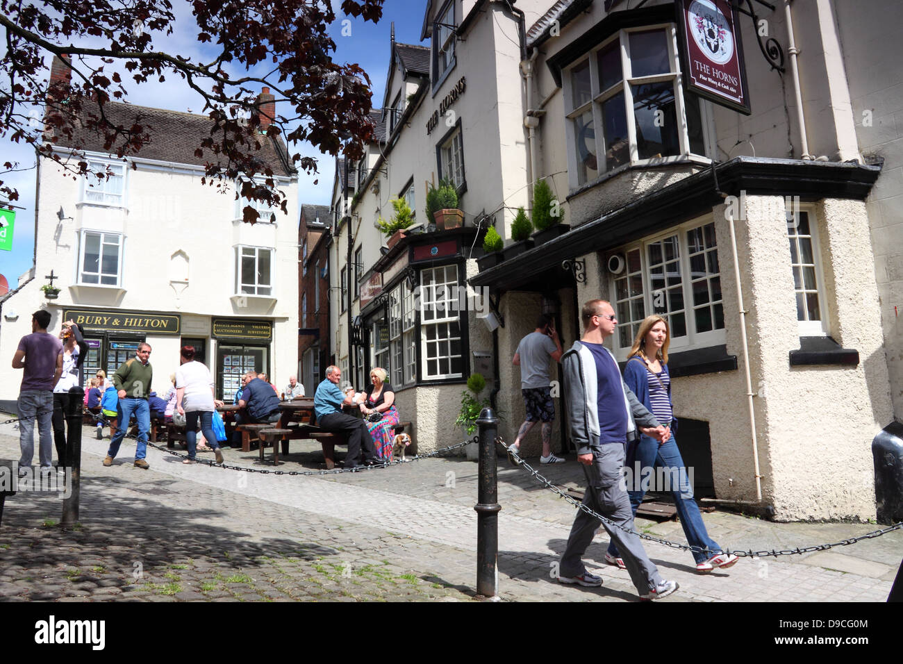 People outside a pub in the pretty market town of Ashbourne, Derbyshire, England Stock Photo