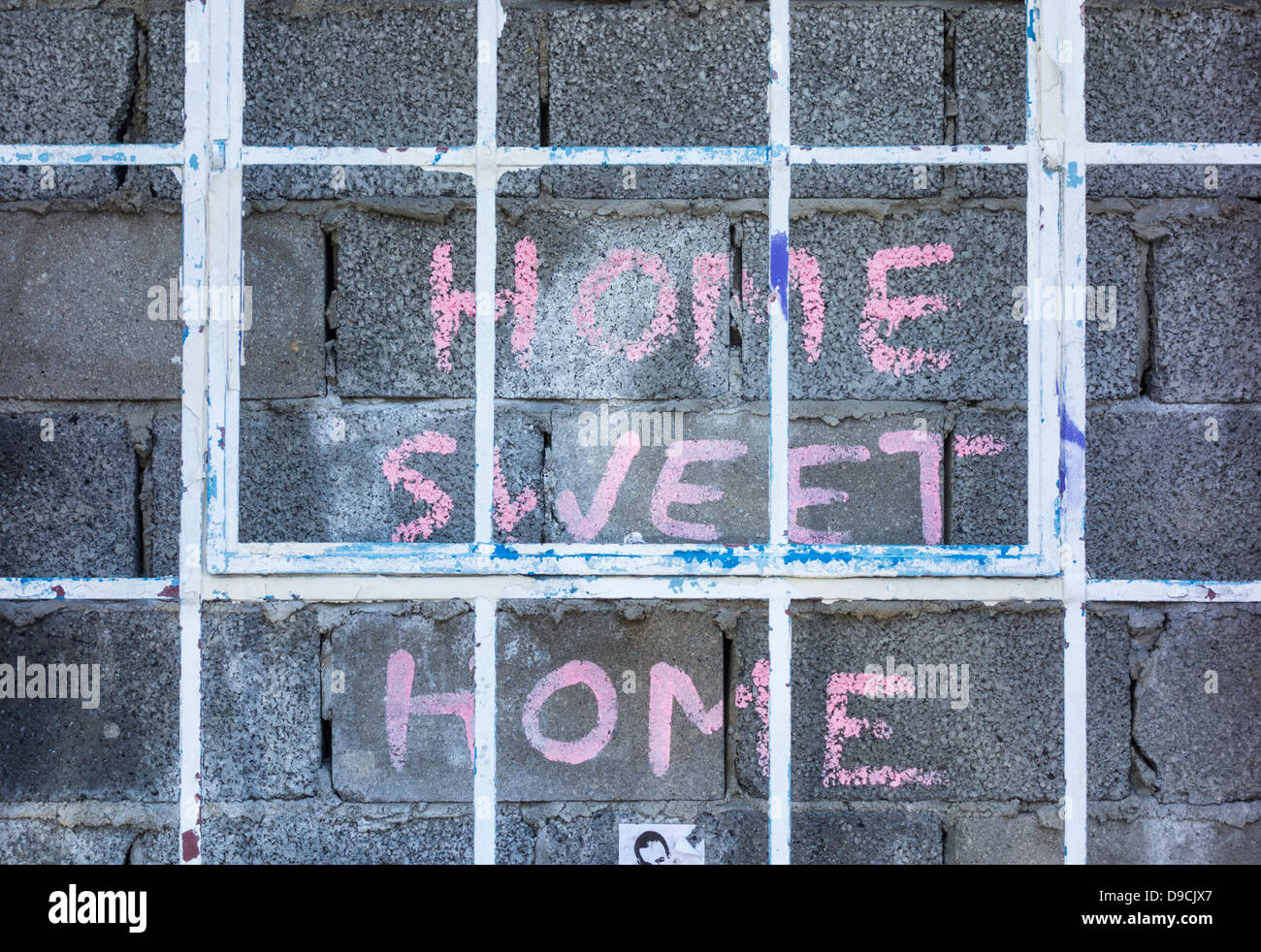 Home sweet home painted on bricked up building Stock Photo