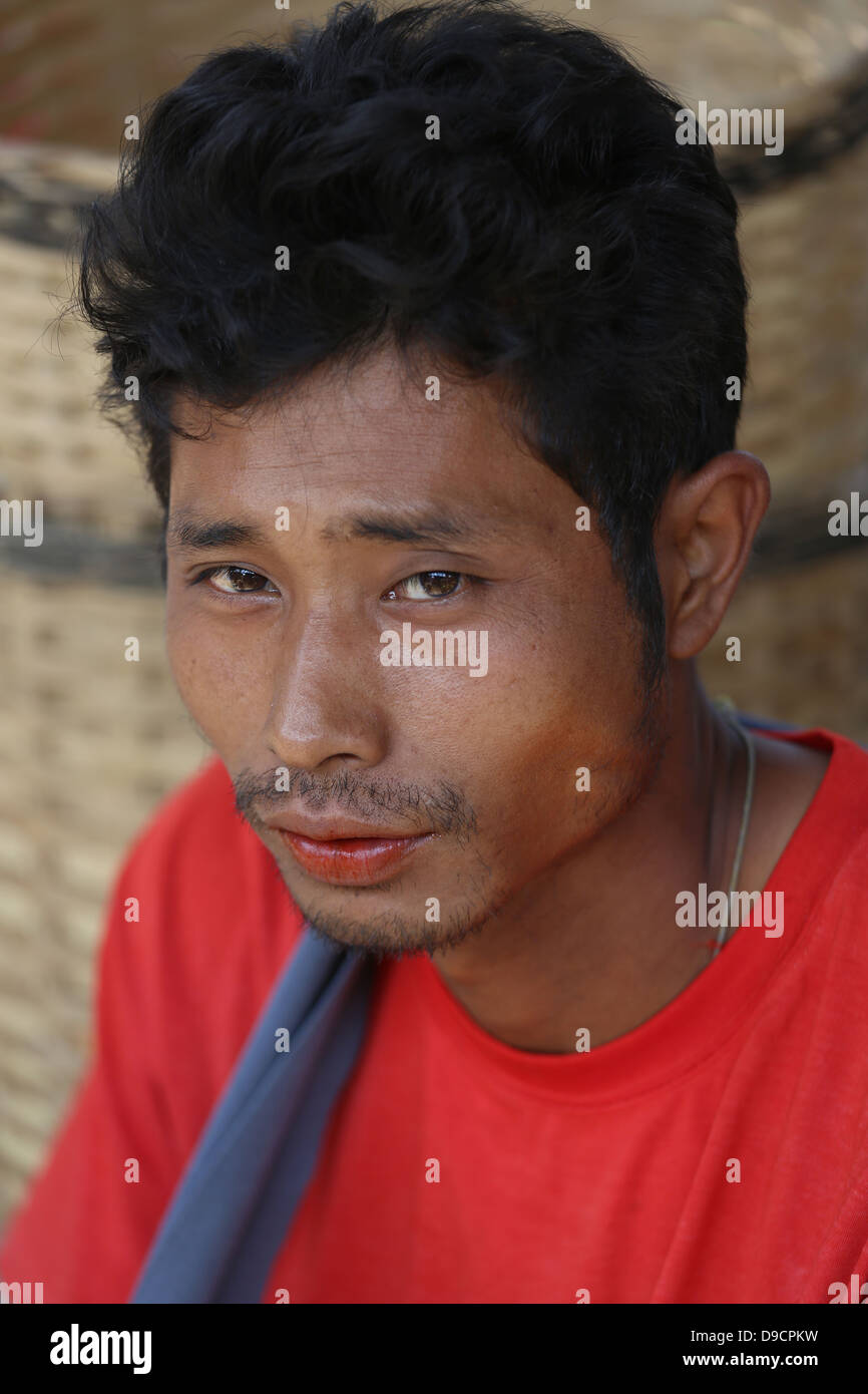 Young man with stained red lips chewing betel leaves at Thaung Tho tribal market on Inle Lake, Myanmar, Southeast Asia Stock Photo