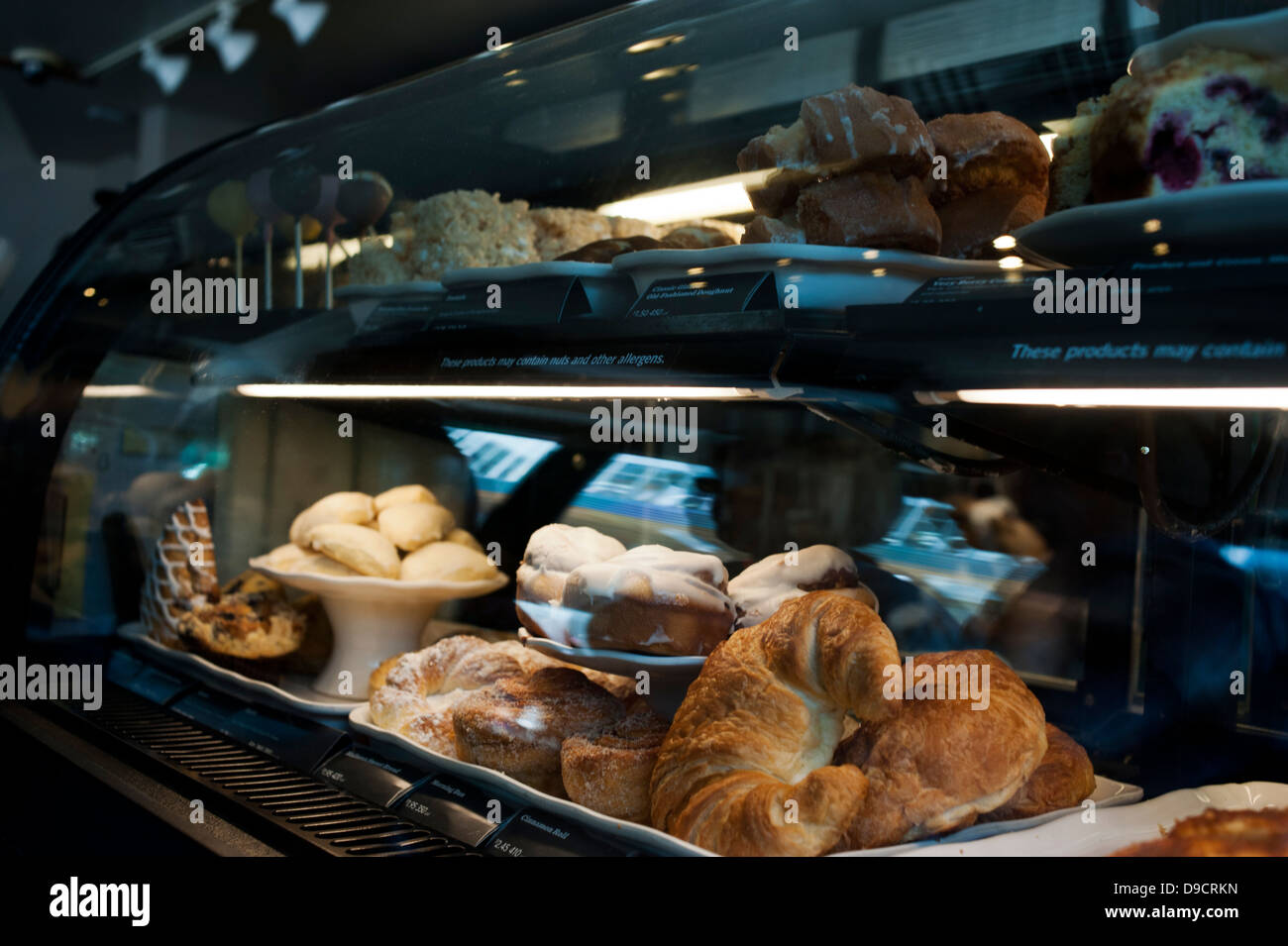 Pastries on display inside of a glass deli counter Stock Photo