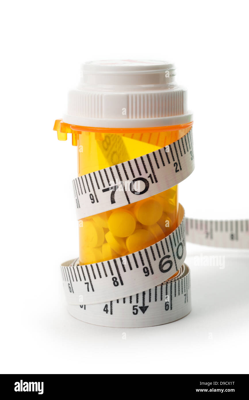 Diet pill concept using measure tape around pill bottle Stock Photo Alamy
