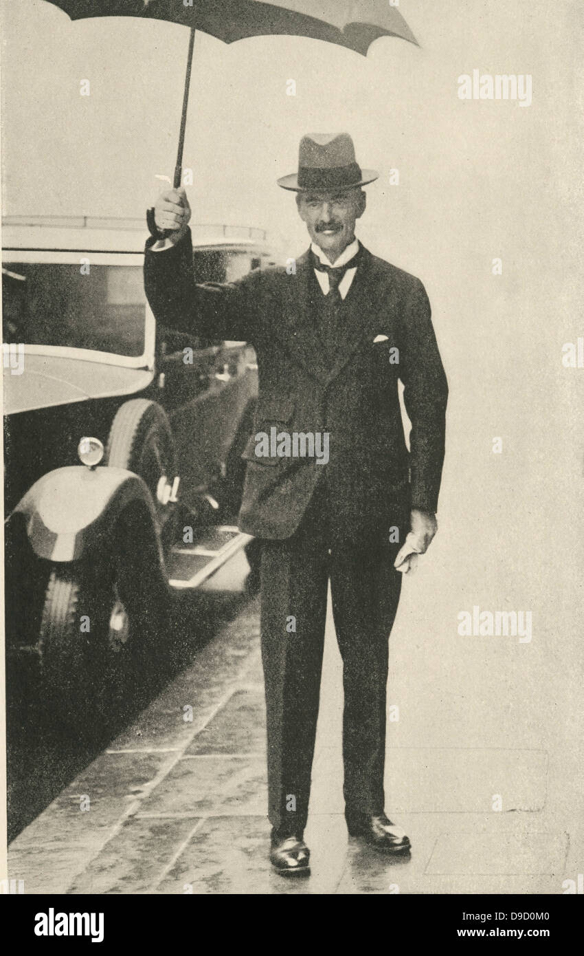 (Arthur) Neville Chamberlain (1869-1940) English Conservative politician, Prime Minister of the United Kingdom 1937-1940, Holding an umbrella in London on a rainy day. Stock Photo