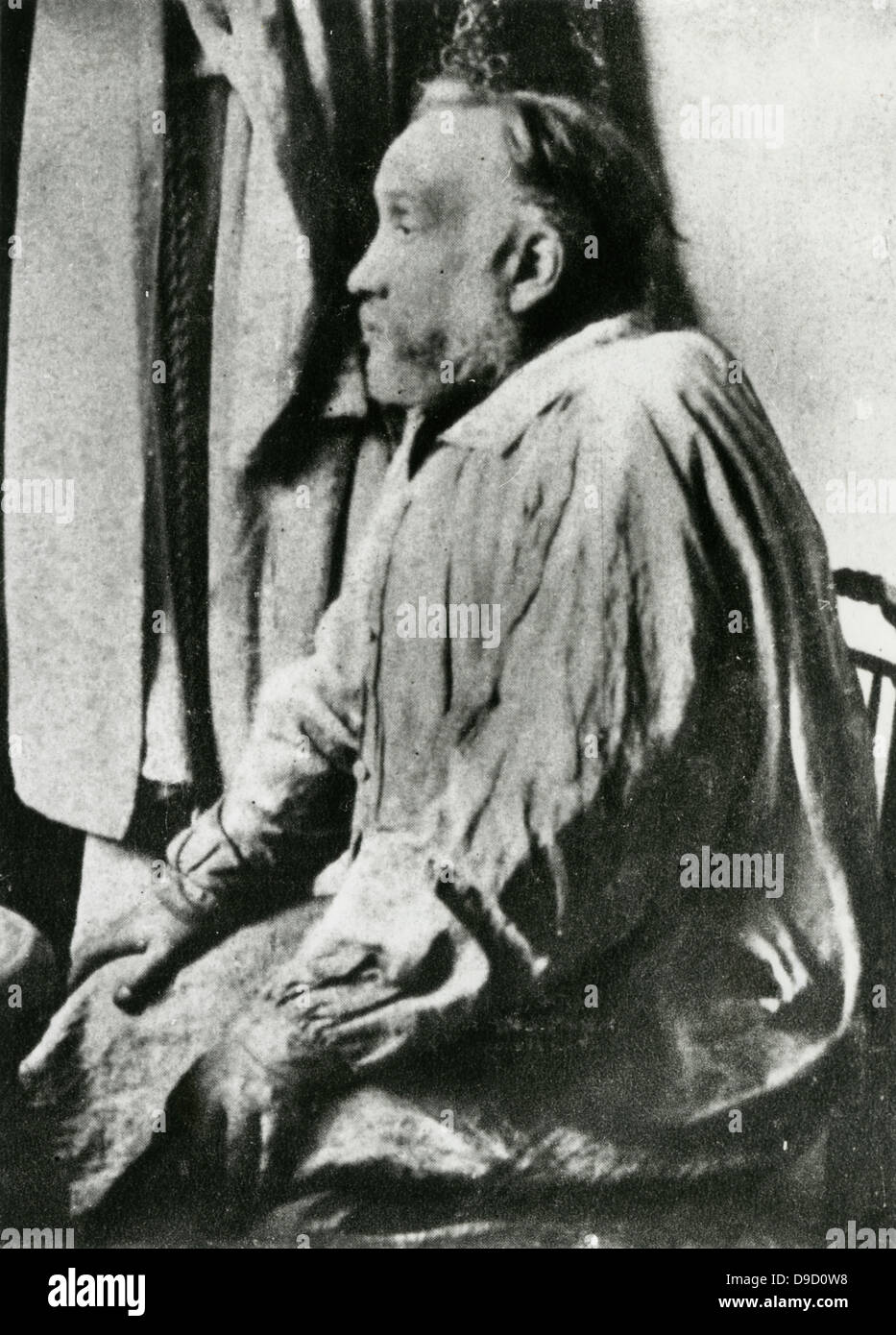 Edgar Degas (1834-1917) French painter, sculptor, and printmaker.  Considered to be one of the founders of Impressionism. Degas, seated, in his painting smock. Stock Photo
