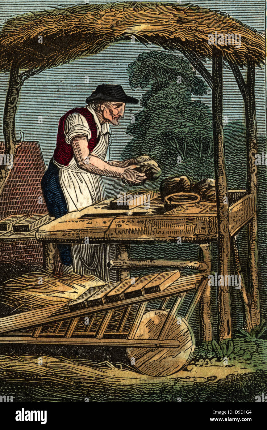 The Brick Maker forming a brick by filling mould with clay. Bricks ...