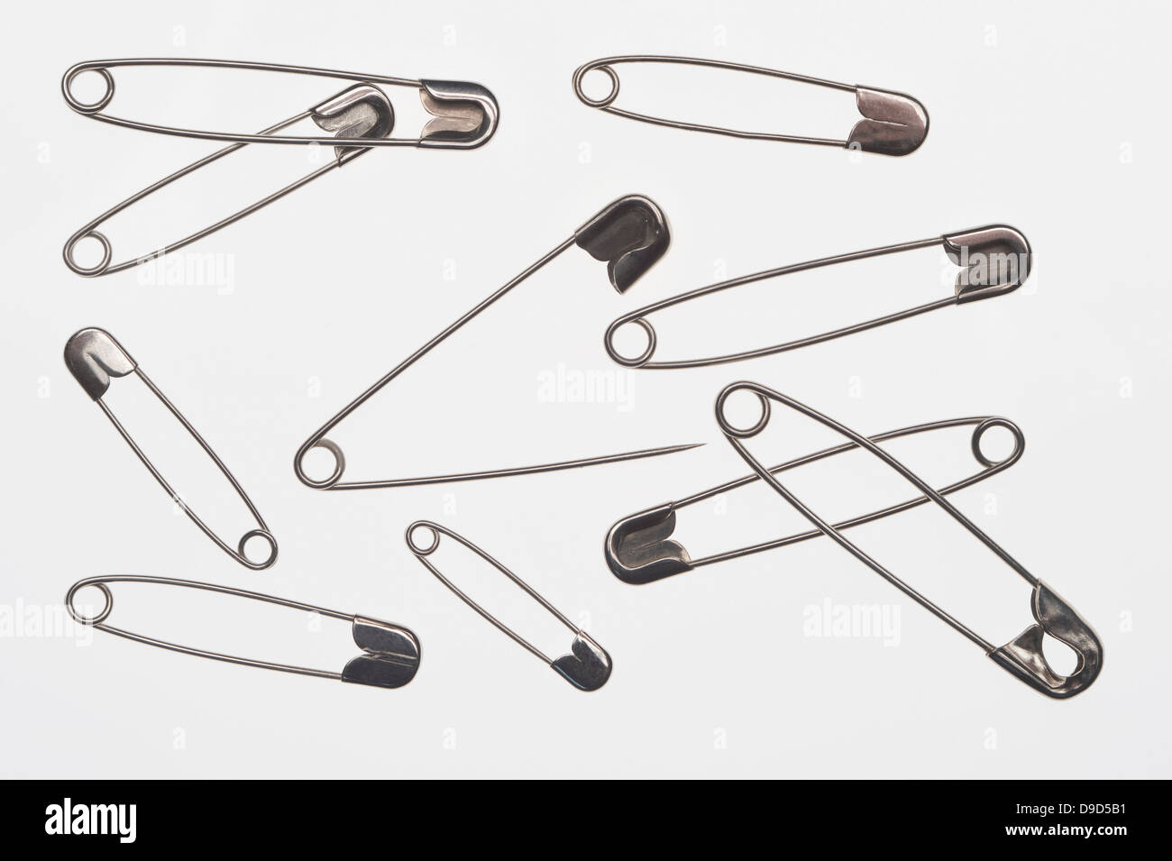 Open and closed safety pins on white background Stock Photo Alamy