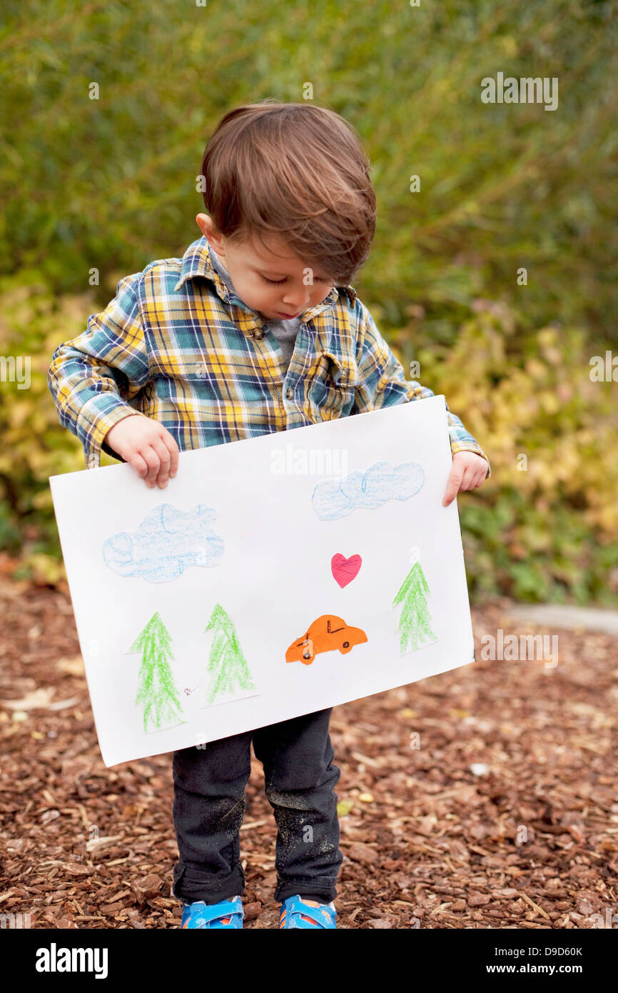 Male toddler holding crayon drawing Stock Photo