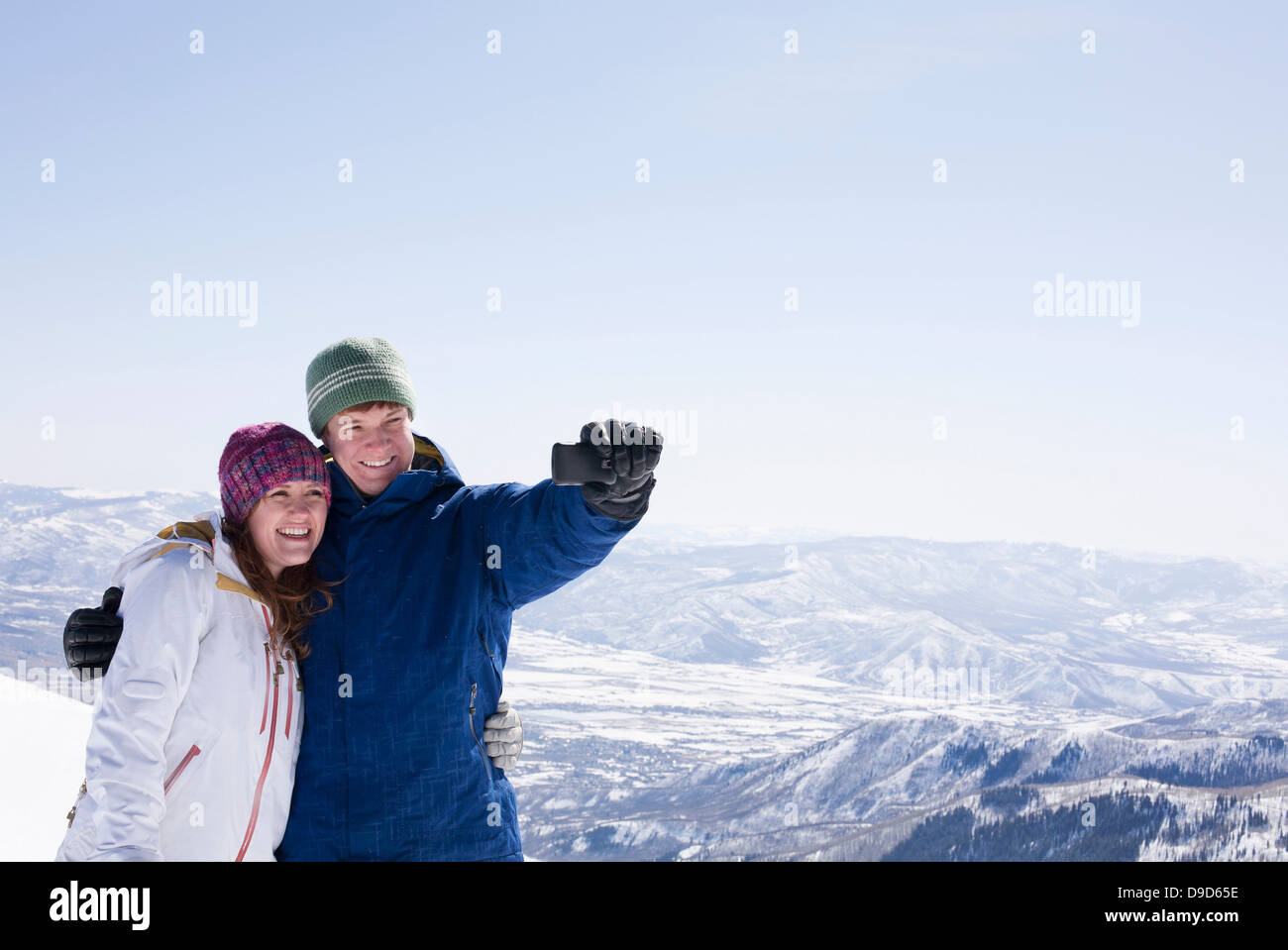 Young couple photographing selves, Brighton ski resort, Utah, USA Stock Photo