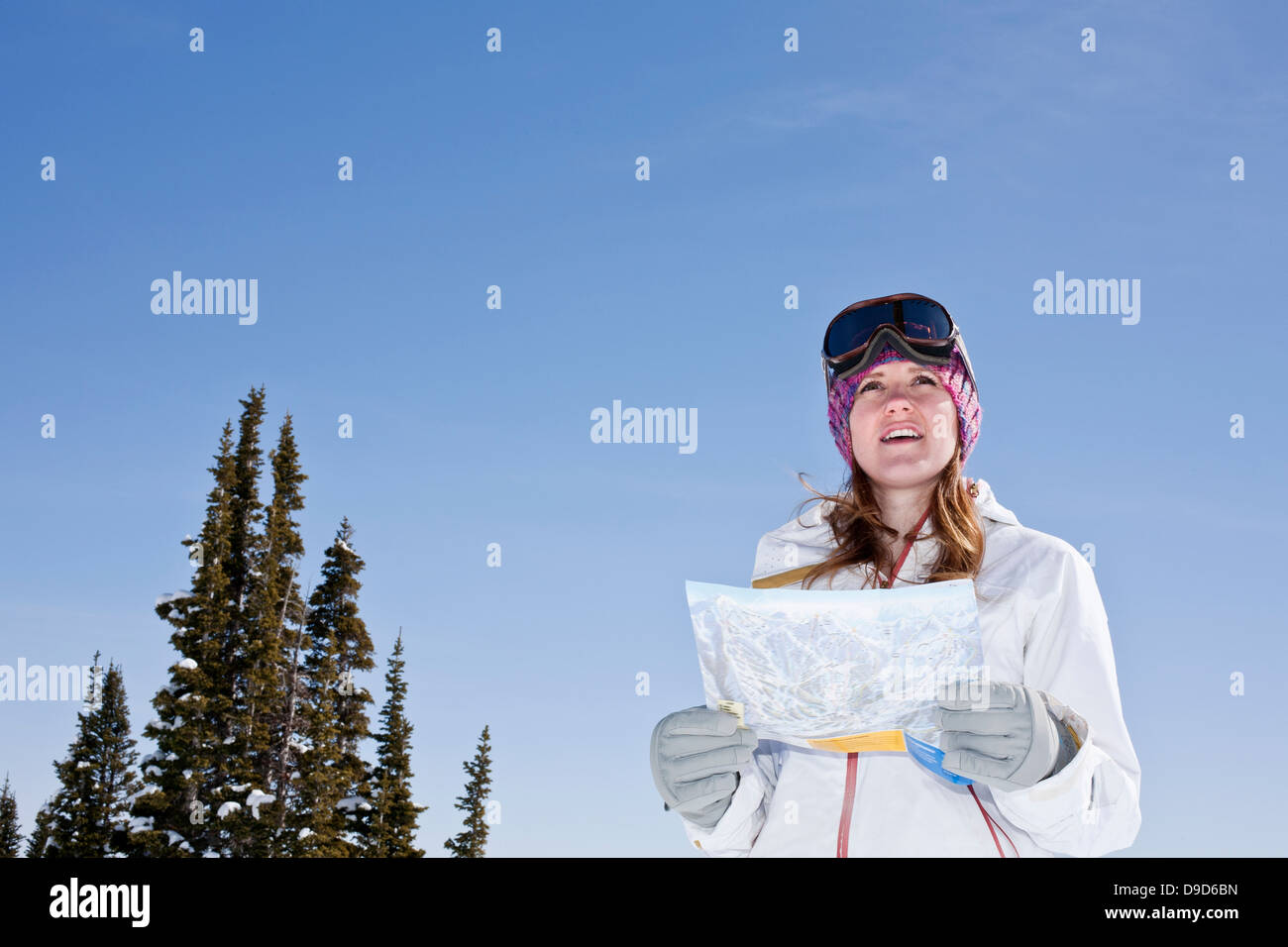 Young woman holding ski map Stock Photo