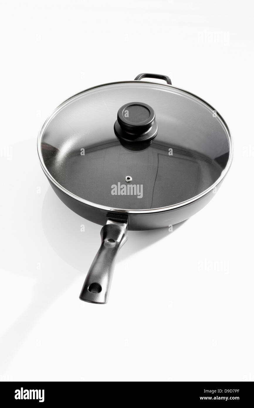 Frying pan with lid on white background, close up Stock Photo