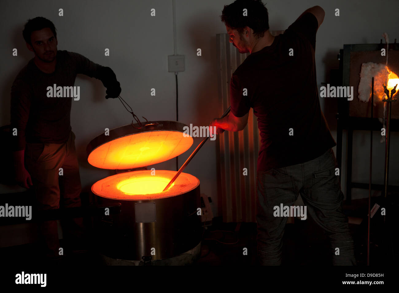 Two men working in glass factory Stock Photo Alamy