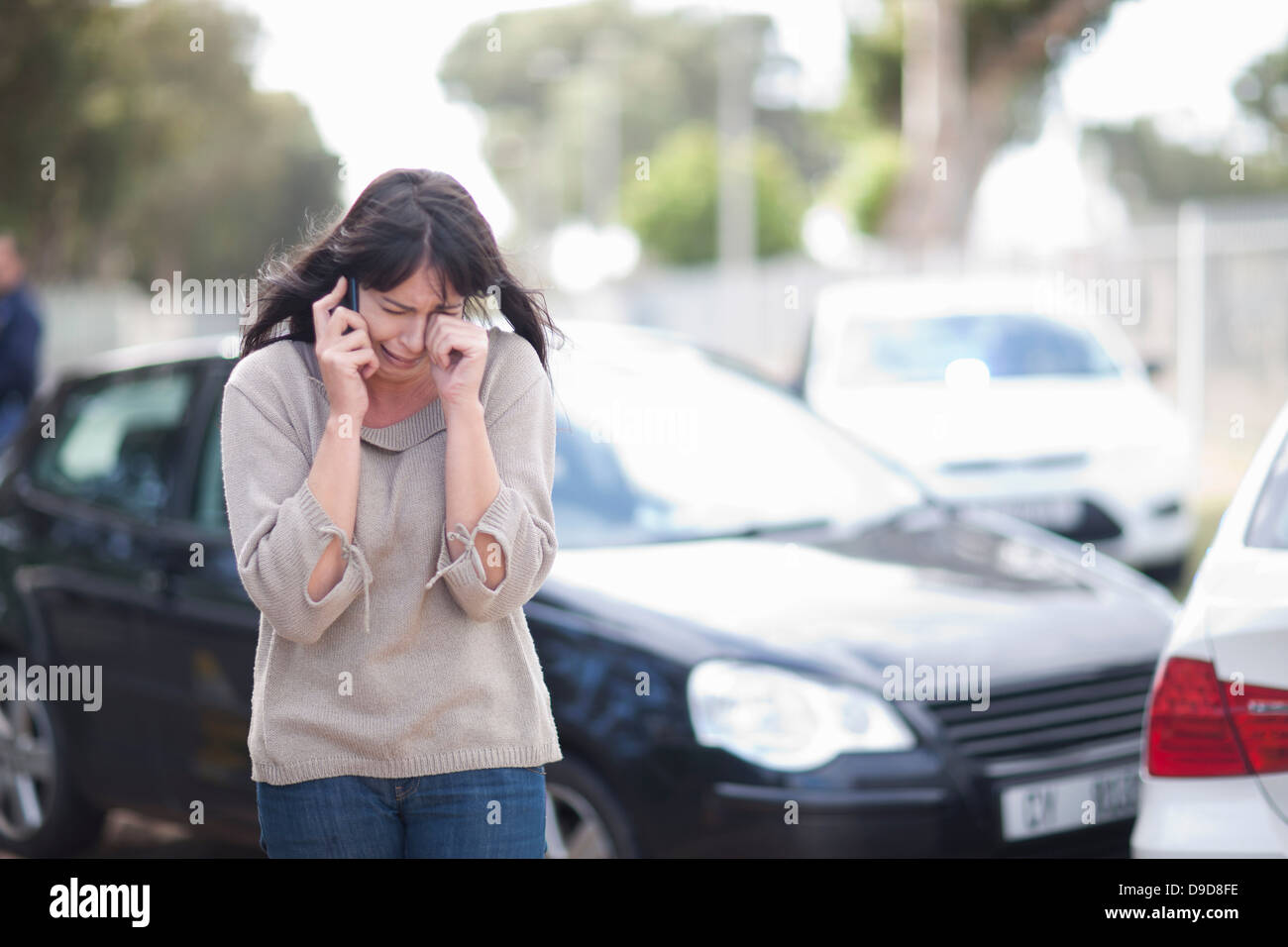 Woman crying after car accident Stock Photo