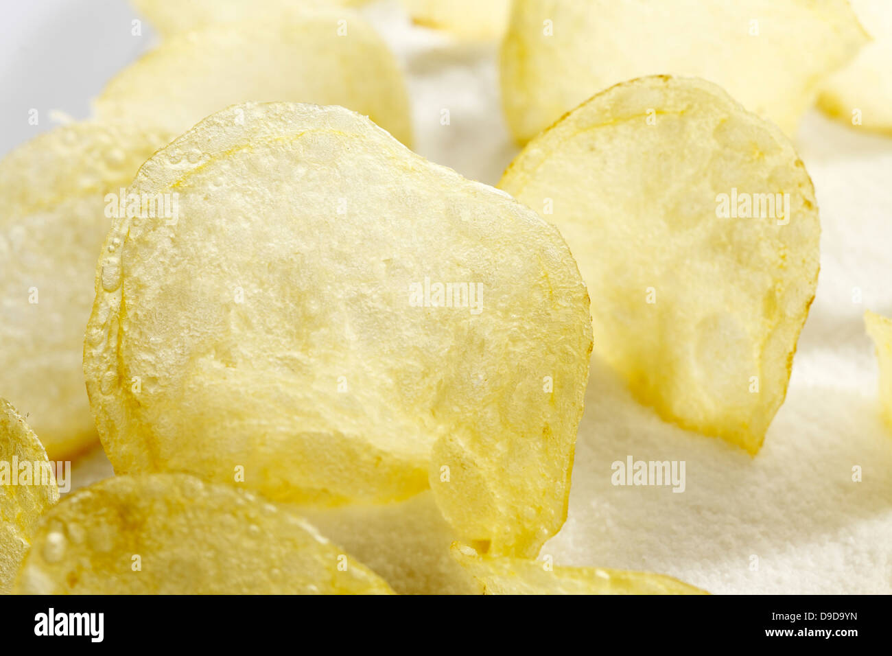 Salted potato chips on salt, close up Stock Photo Alamy