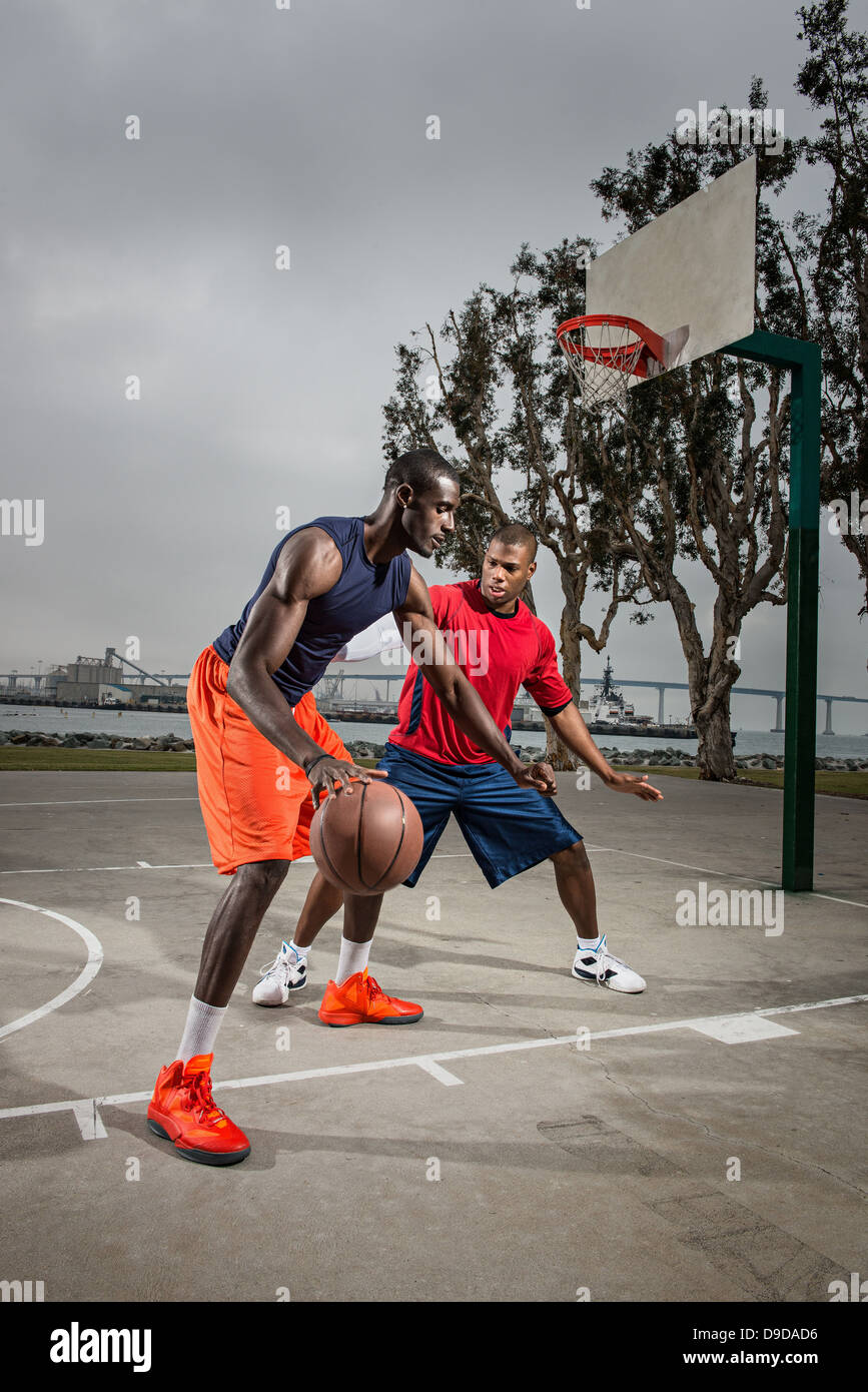 Young basketball players playing on court Stock Photo