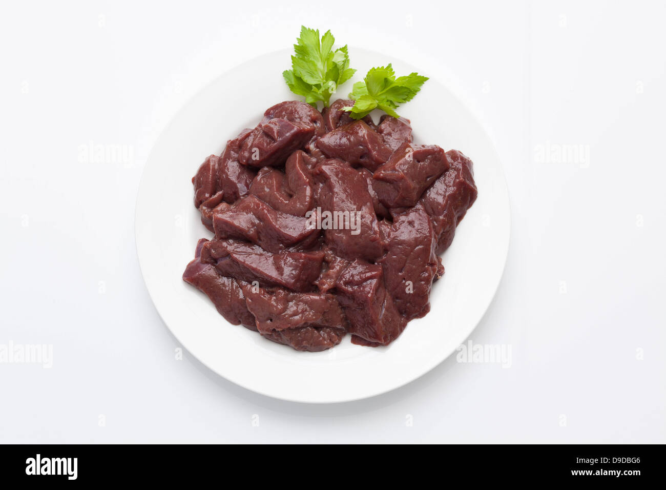 Calf liver pieces in plate on white background Stock Photo Alamy