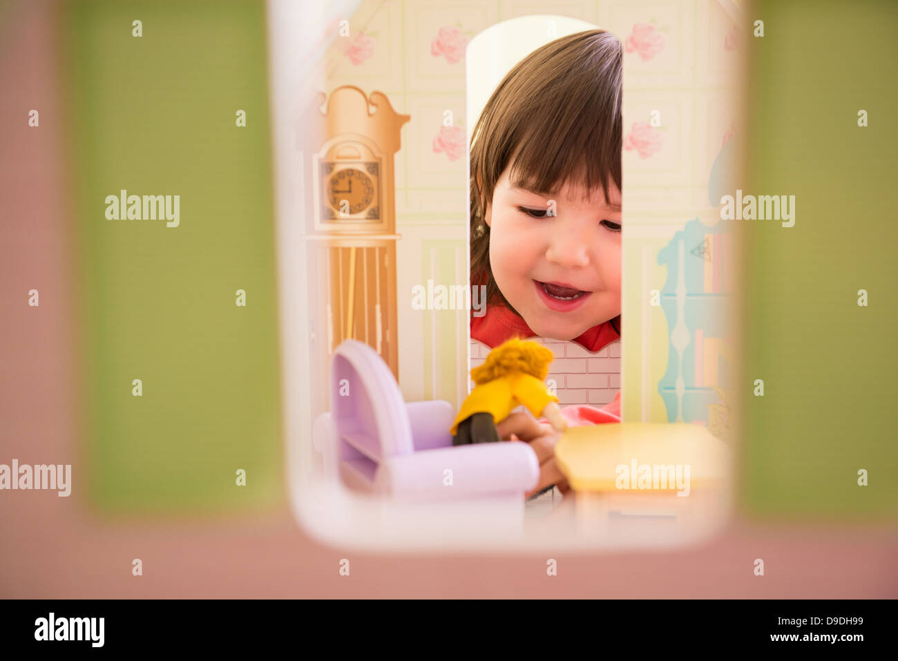 Girl playing with doll house Stock Photo - Alamy