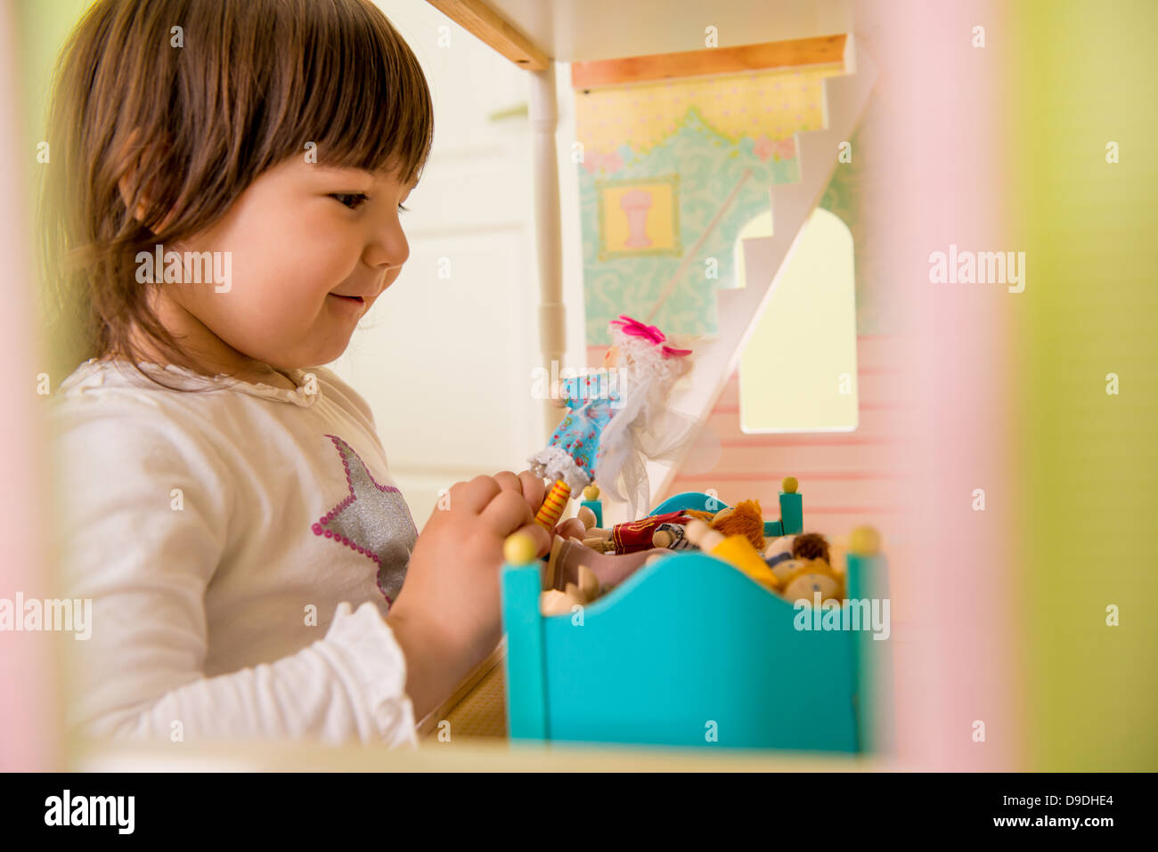Girl playing with doll house Stock Photo - Alamy