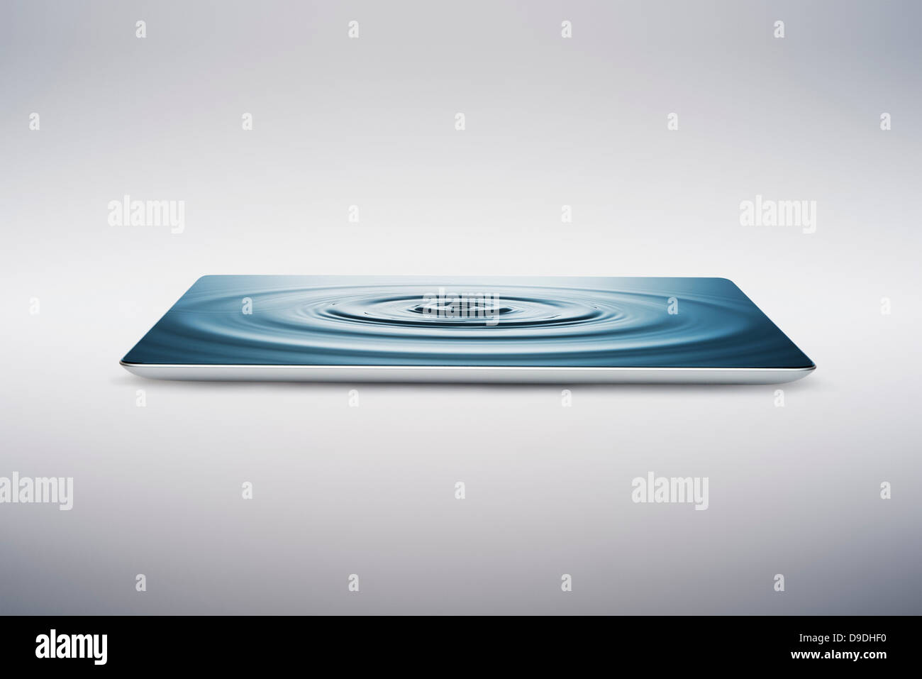 Digital tablet with water ripple on screen Stock Photo