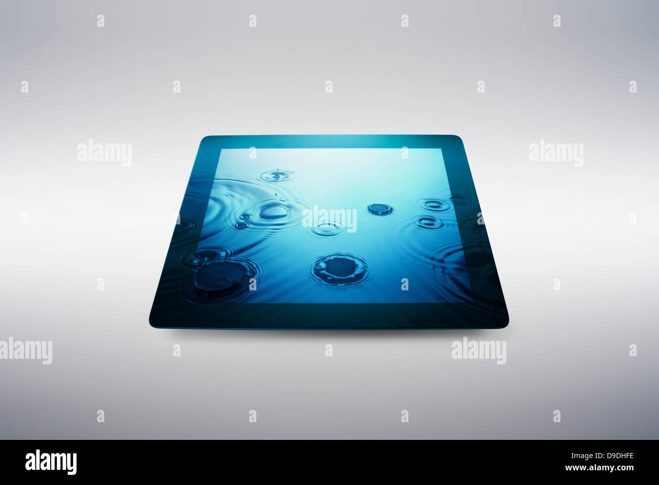 Digital tablet with water drop effect on screen Stock Photo