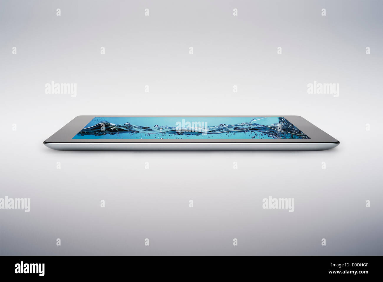 Digital tablet with gently rising bubbling water on screen Stock Photo