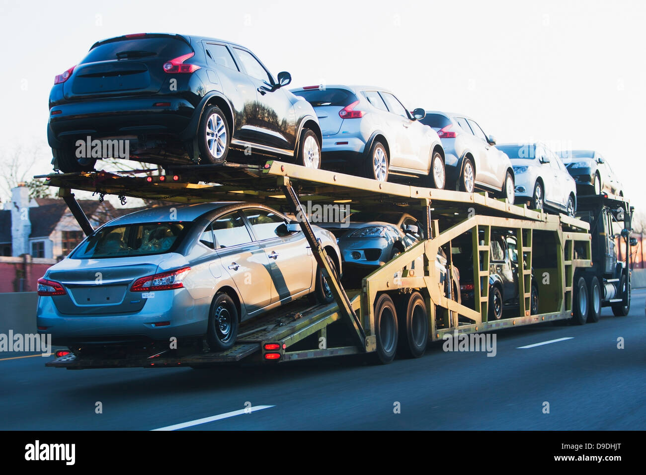 Cars transported on truck on highway Stock Photo