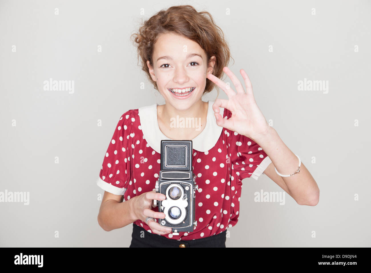 Girl holding old camera Stock Photo