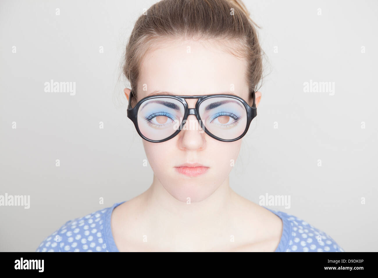 Girl wearing fake glasses Stock Photo - Alamy