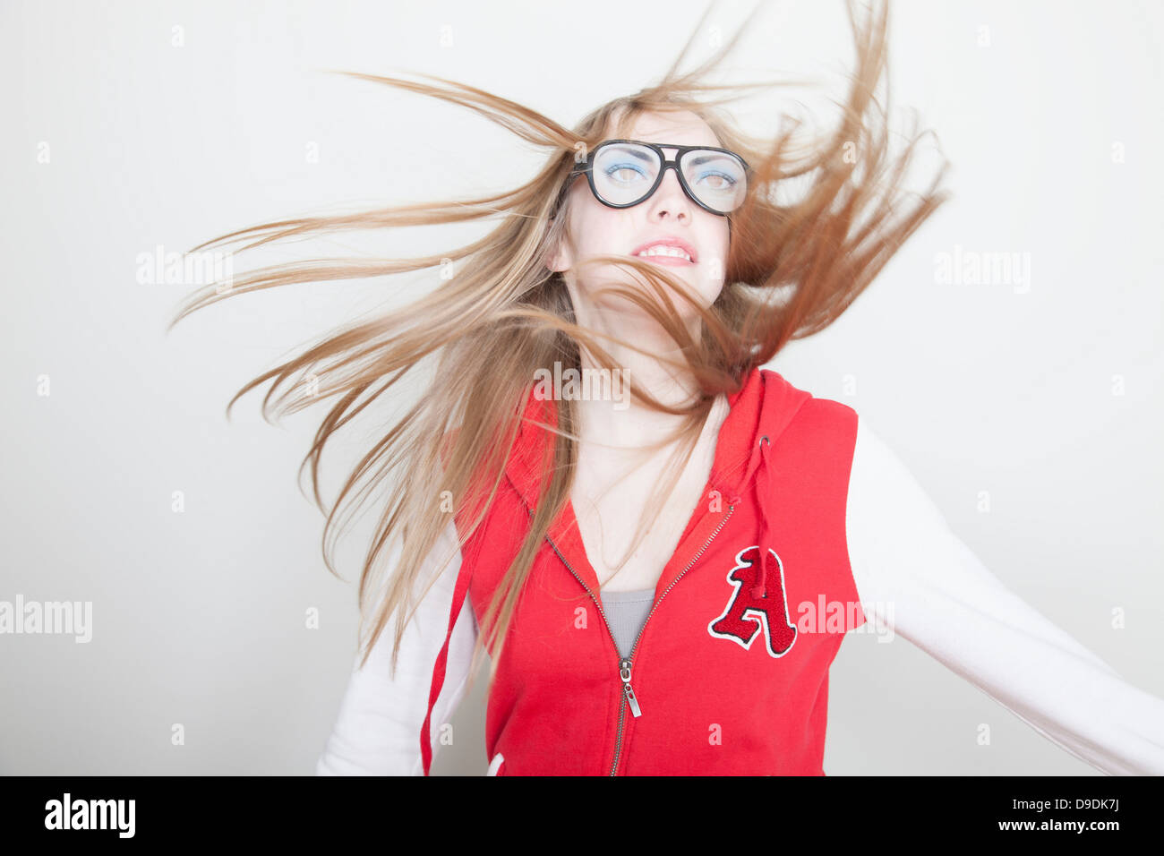 Girl wearing fake glasses swinging hair Stock Photo