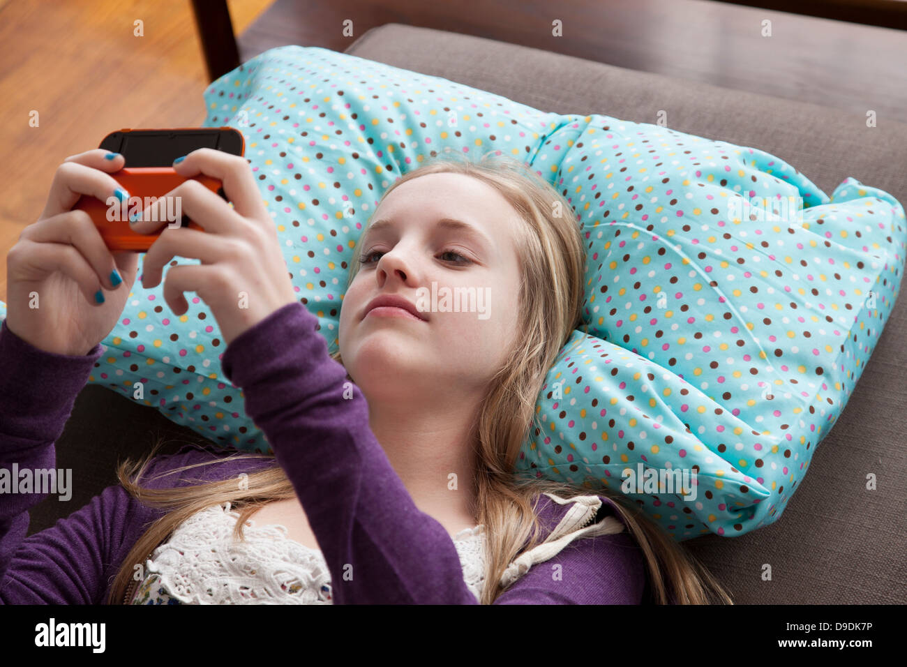 Girl lying on sofa hi-res stock photography and images - Alamy