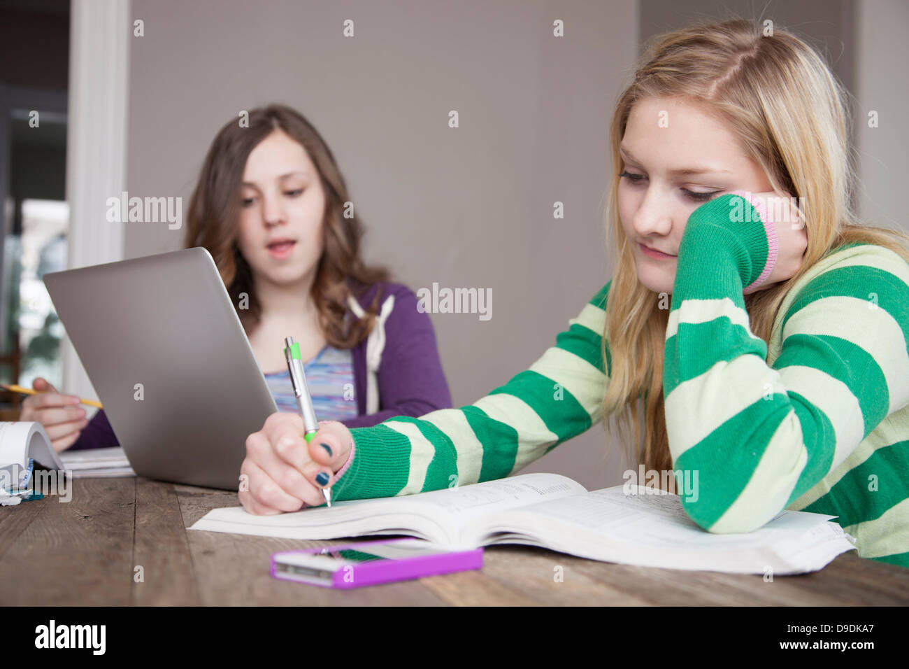 Girls sitting at table studying Stock Photo
