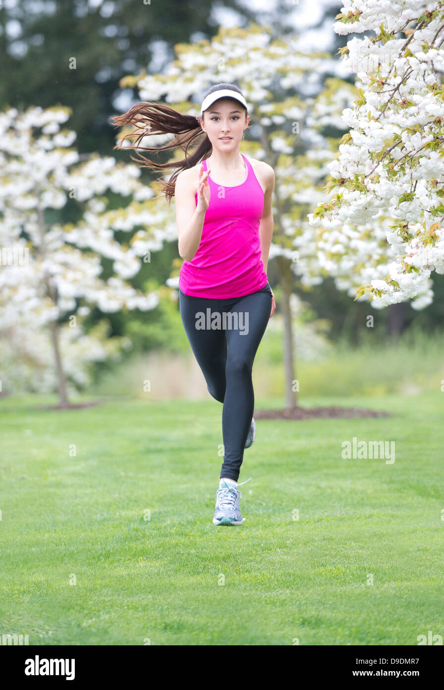 https://c8.alamy.com/comp/D9DMR7/teenage-girl-wearing-pink-sportswear-running-in-park-D9DMR7.jpg