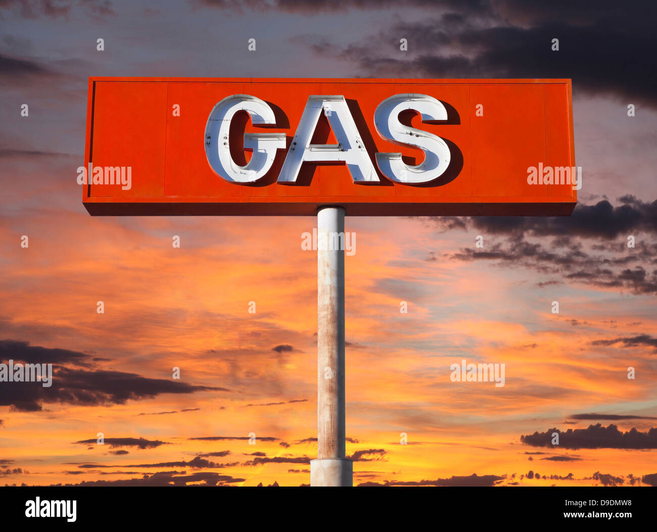 Vintage neon gas sign with sunset sky. Stock Photo