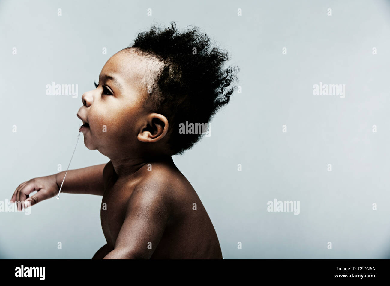 Portrait of baby boy dribbling Stock Photo Alamy
