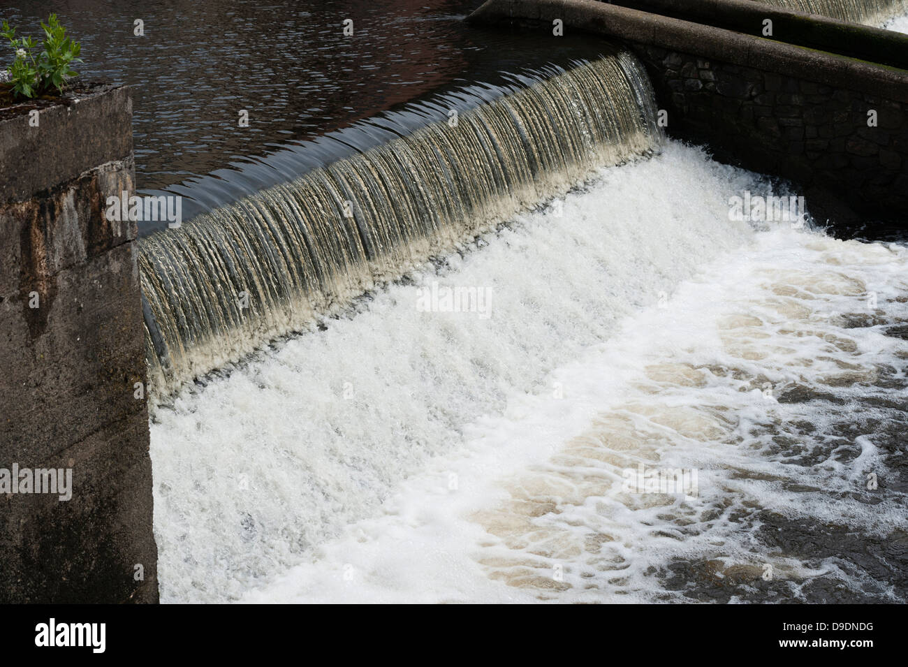 a dam overflowing river stream water weir wier UK Stock Photo Alamy