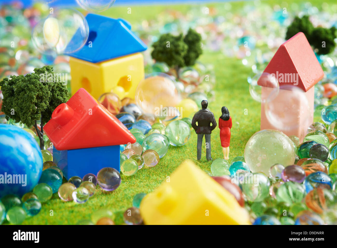 Figurines and houses made from plastic blocks with marbles Stock Photo