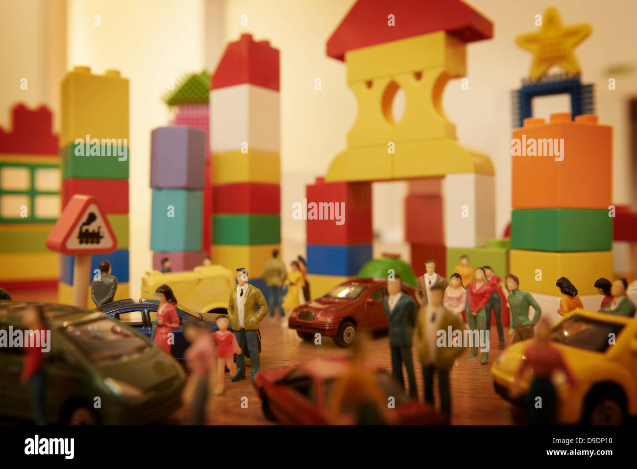 Toy cars and figurines in pretend plastic block town Stock Photo