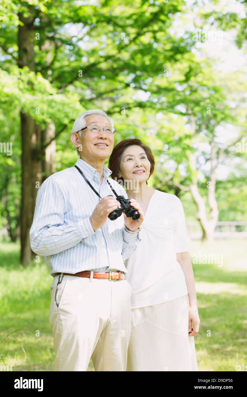 Senior couple with binoculars looking away Stock Photo