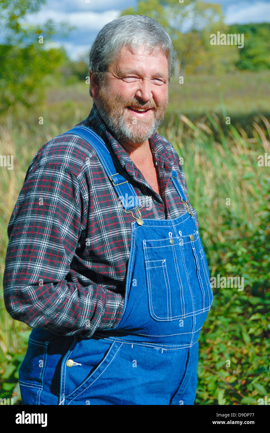 portrait of grey haired bearded farmer, wearing bib overalls & plaid shirt  in meadow Stock Photo - Alamy