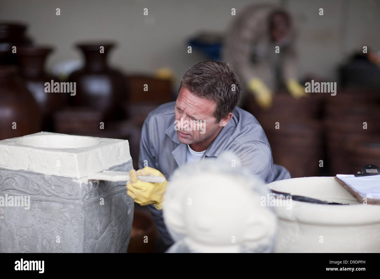 Painting and staining process in pottery factory Stock Photo Alamy