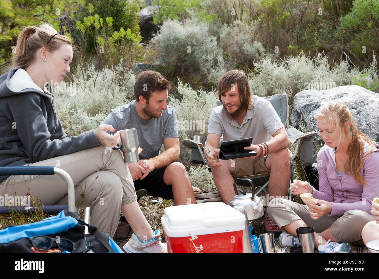 Group of young hikers taking a lunch break Stock Photo