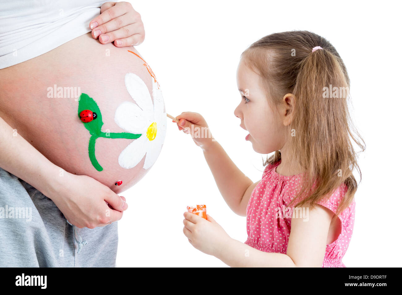 cute kid girl painting mother's belly Stock Photo