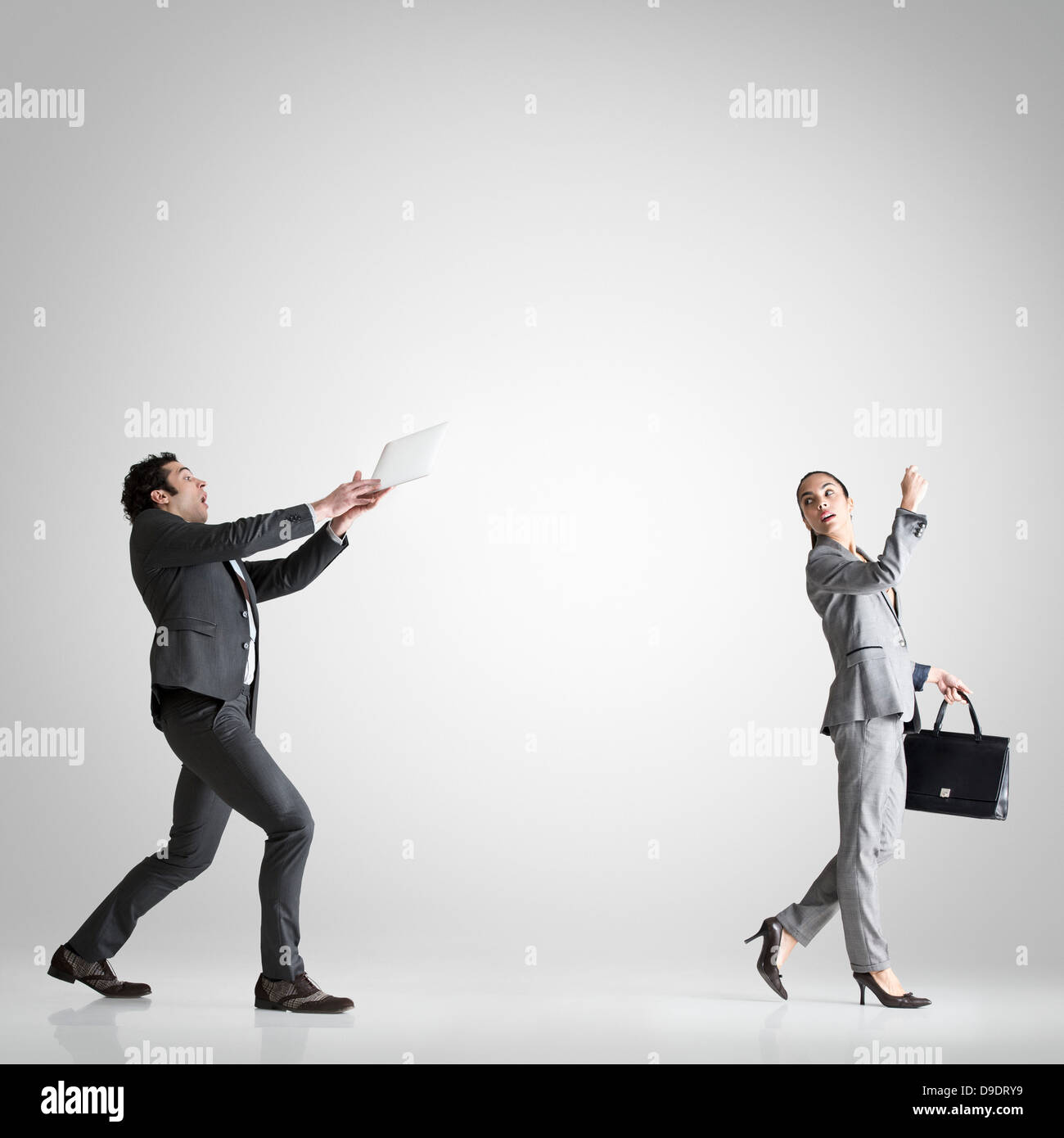 Woman throwing digital table to man Stock Photo Alamy