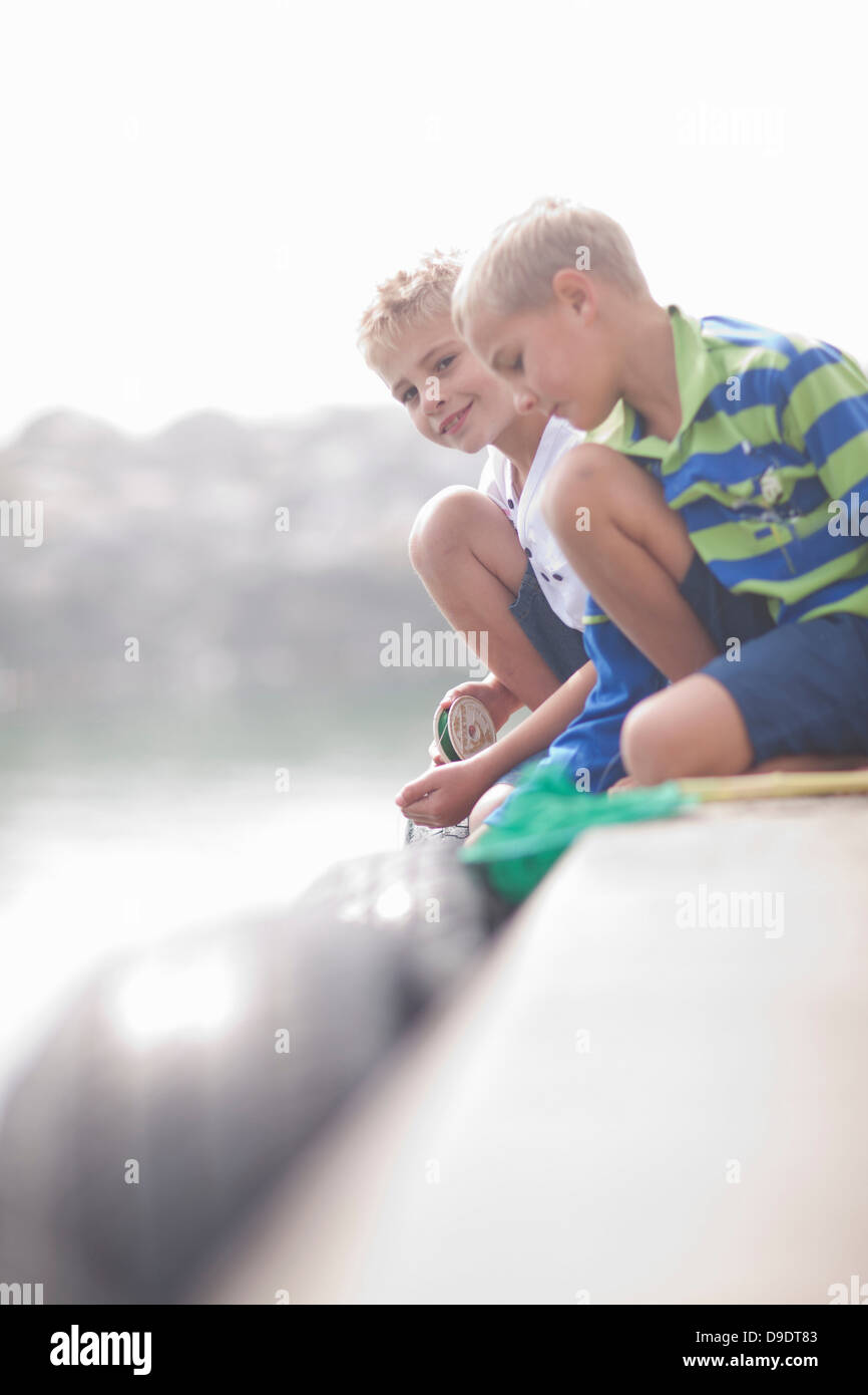 Two boys sitting fishing hi-res stock photography and images - Alamy