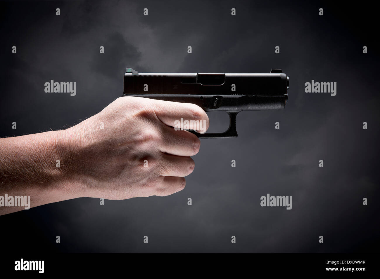 Person holding handgun Stock Photo Alamy