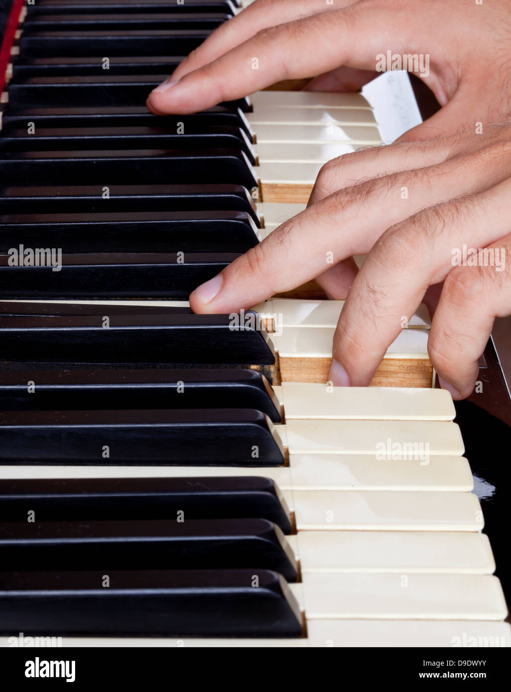 Piano keyboard made of ivory with hands Stock Photo Alamy