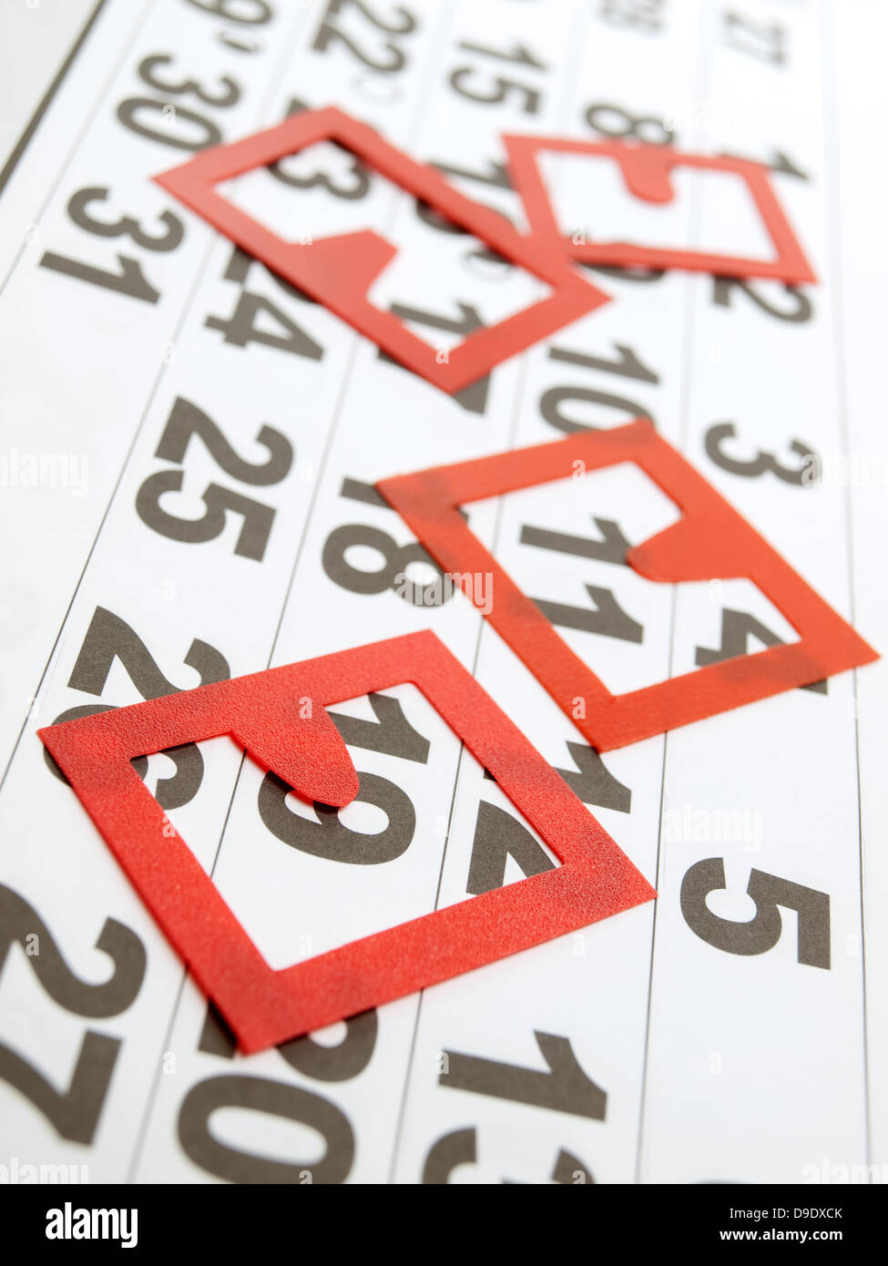 Generic calendar sheet with several red marking badges on it. Stock Photo