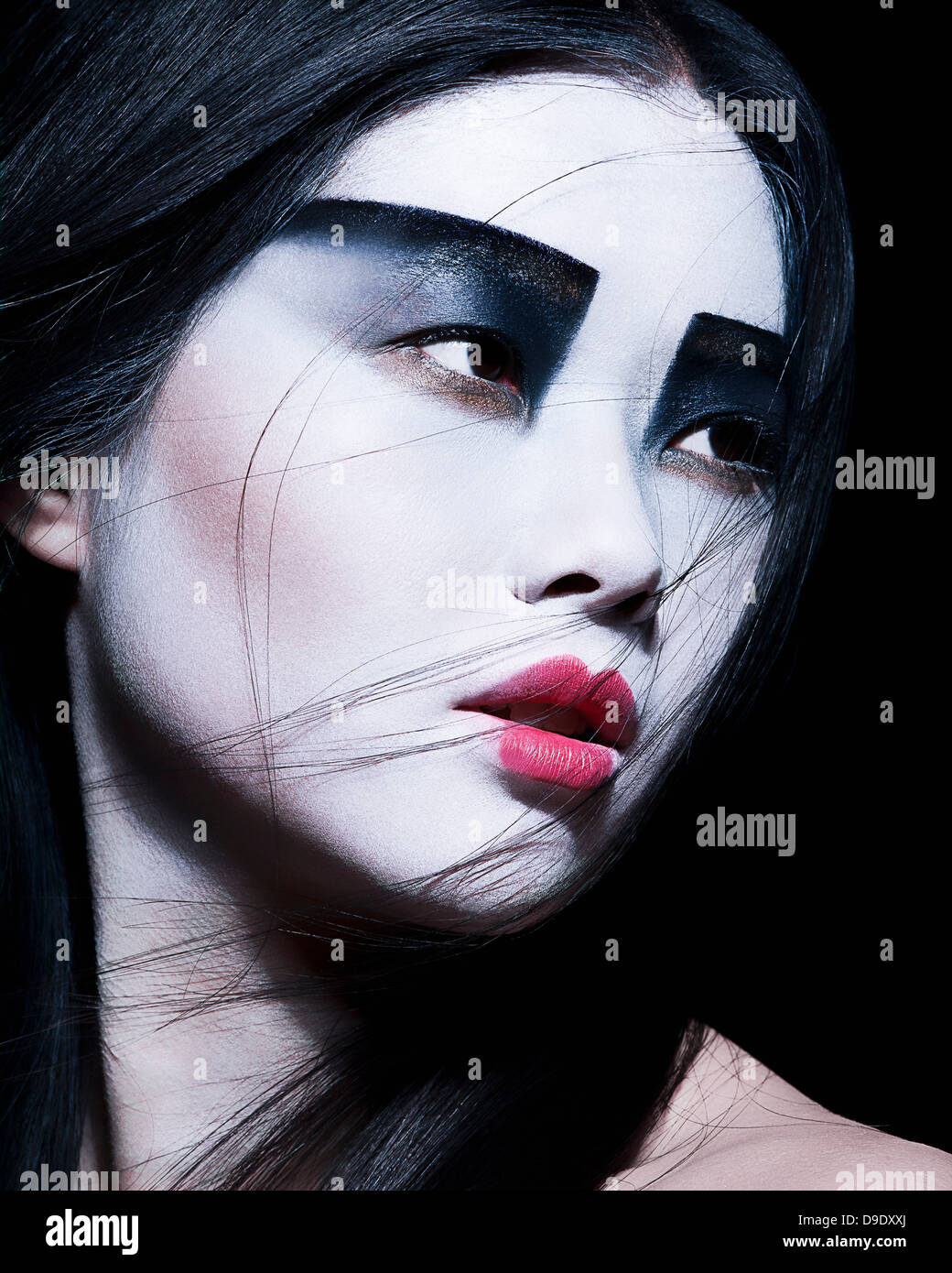 Dramatic portrait of young female with horror black stage makeup painted on  face and orange color dreadlocks hairstyle. Studio shot on blue background  Stock Photo - Alamy