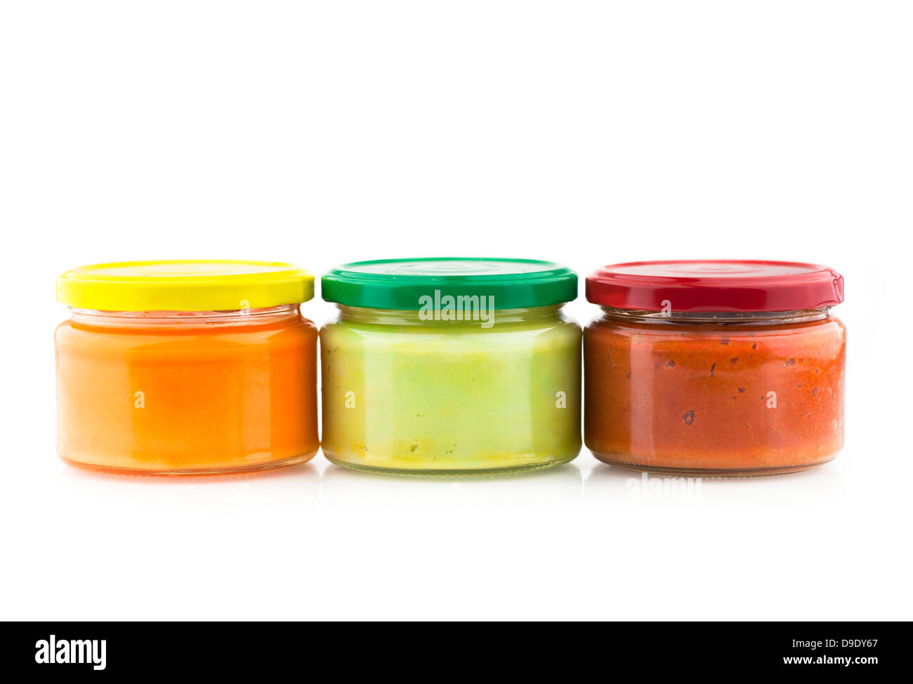 Traditional Mexican dips made of cheese, guacamole and tomato chutney in jars. Stock Photo