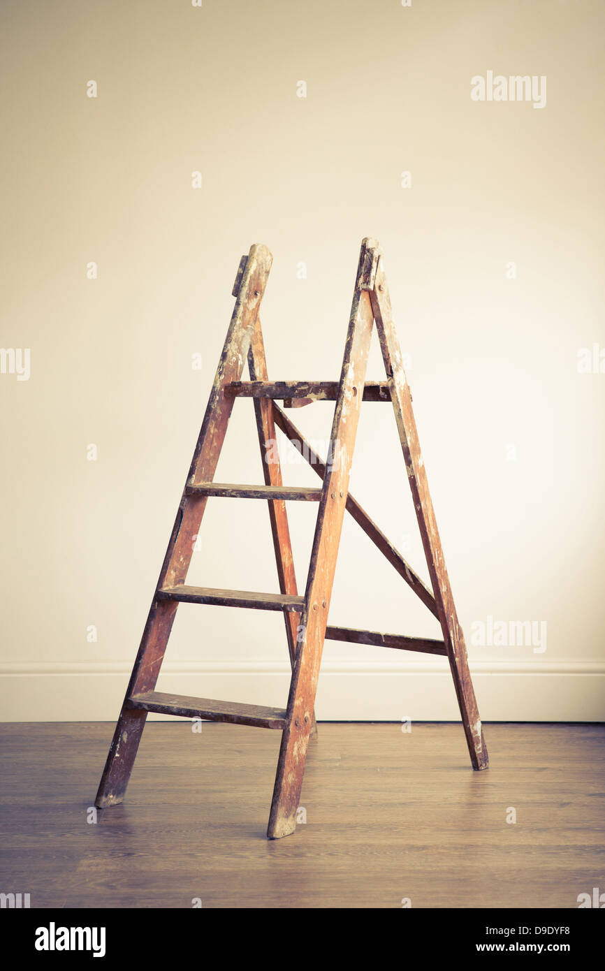 A wooden stepladder placed in an empty room Stock Photo