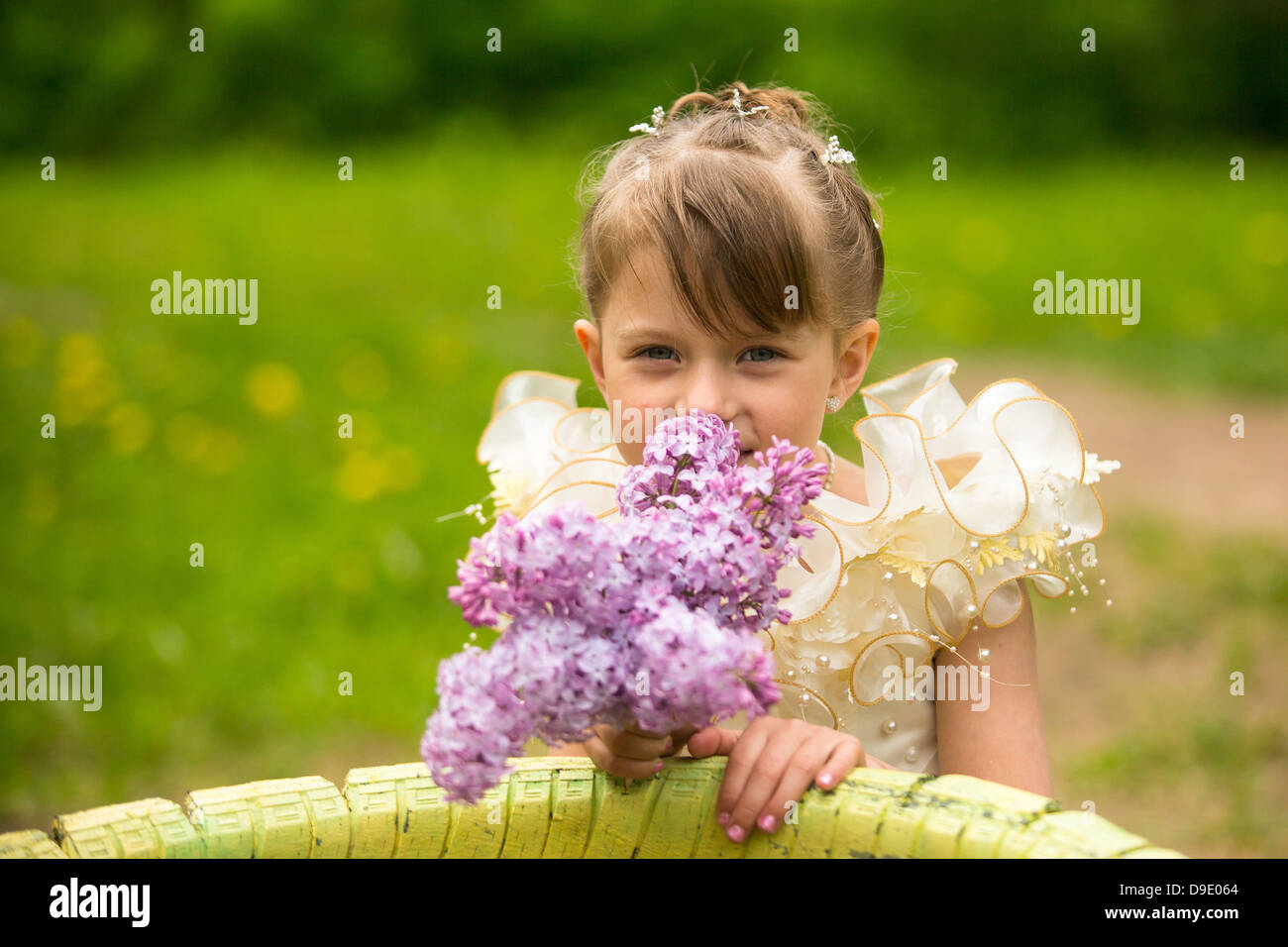 Portrait of a little girl with a bouquet of lilacs Stock Photo - Alamy