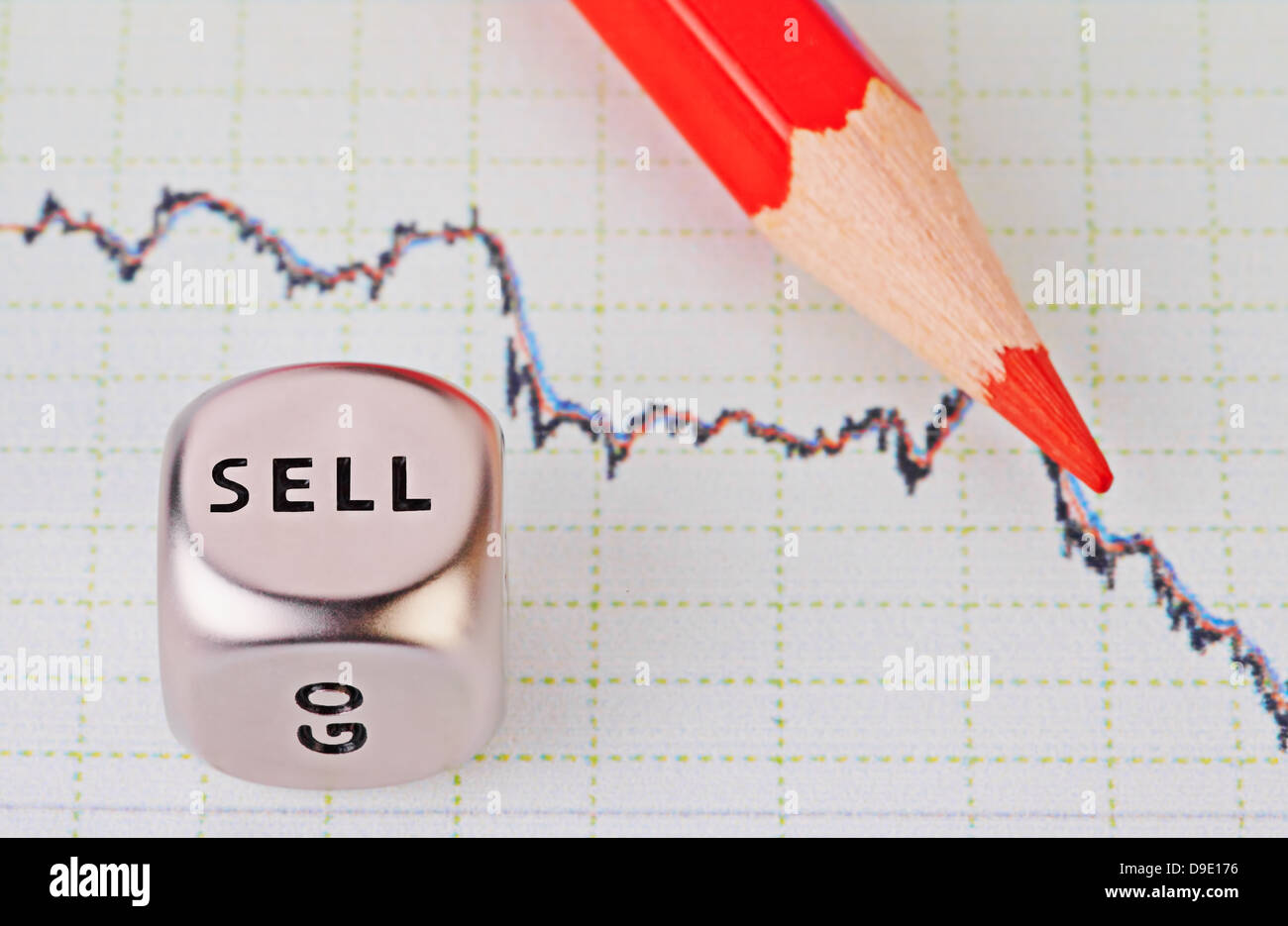 Downtrend chart,red pencil and dice cube with the word SELL. Selective focus Stock Photo